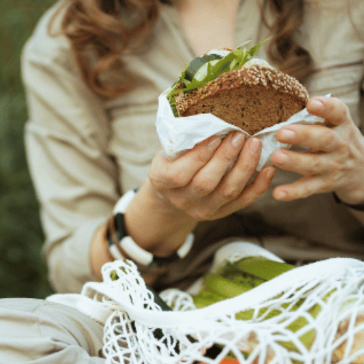 Close up of sandwich being held by a female