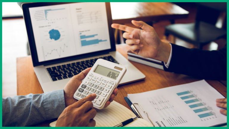 Close up of a calculator being held over the two discussions of reports