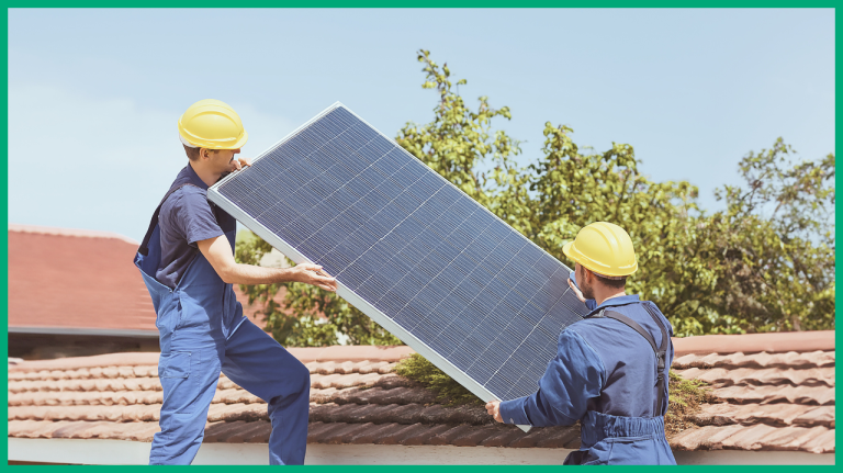 Two people holding and placing a solar panel on the roof